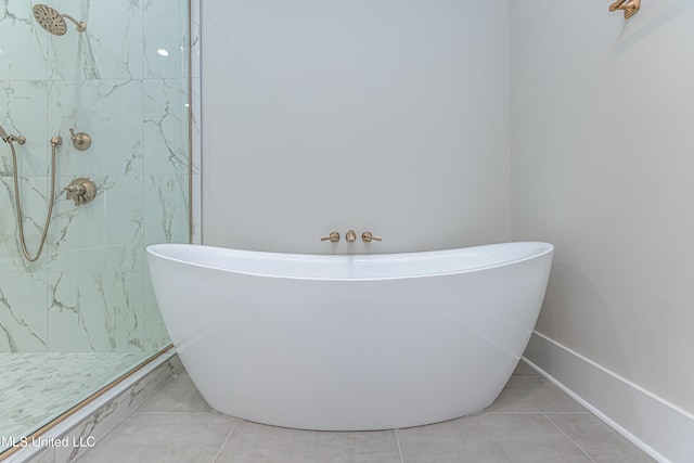 bathroom featuring tile patterned floors and separate shower and tub