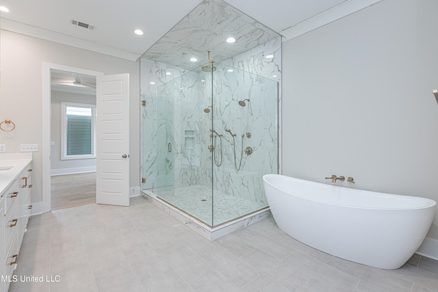 bathroom with tile patterned flooring, vanity, and separate shower and tub