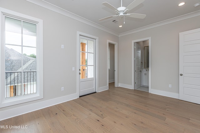 spare room featuring light hardwood / wood-style floors, ceiling fan, and ornamental molding