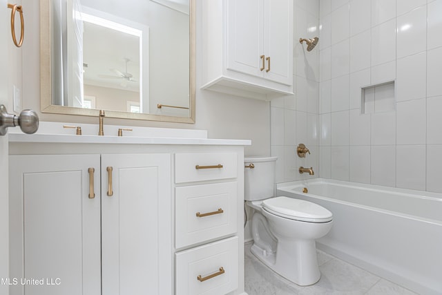 full bathroom featuring tile patterned floors, toilet, tiled shower / bath, vanity, and ceiling fan