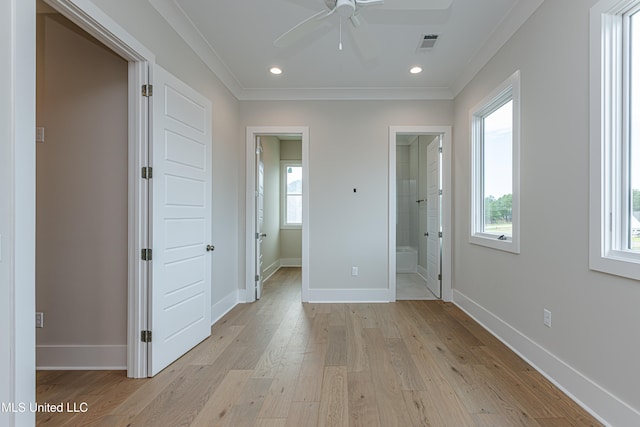 unfurnished bedroom featuring ensuite bathroom, ceiling fan, crown molding, and light hardwood / wood-style floors