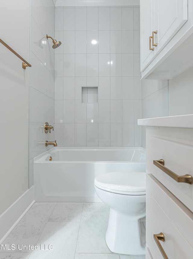 full bathroom featuring vanity, tile patterned floors, toilet, and tiled shower / bath combo