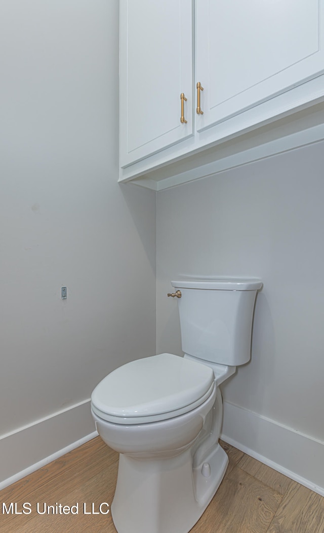 bathroom with wood-type flooring and toilet