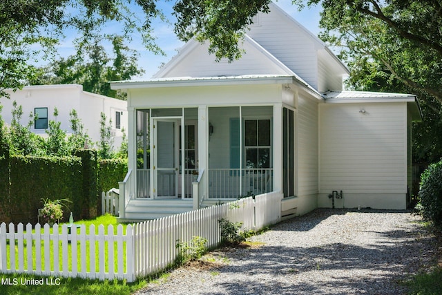 view of side of property featuring a sunroom