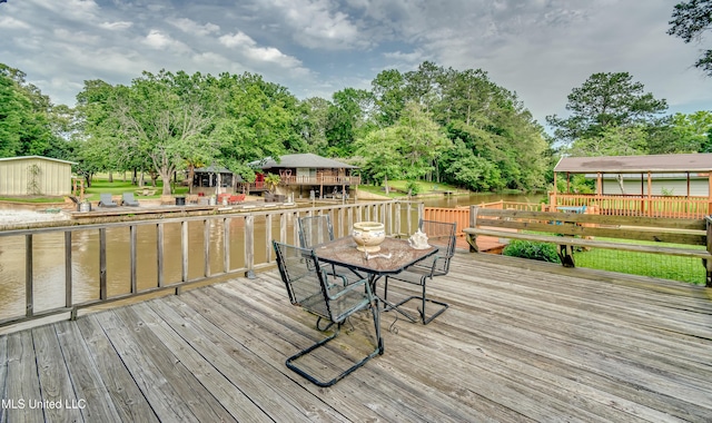 218 Harbor Ln, Brandon, MS 39047 - deck featuring outdoor dining area, a water view, and view of scattered trees