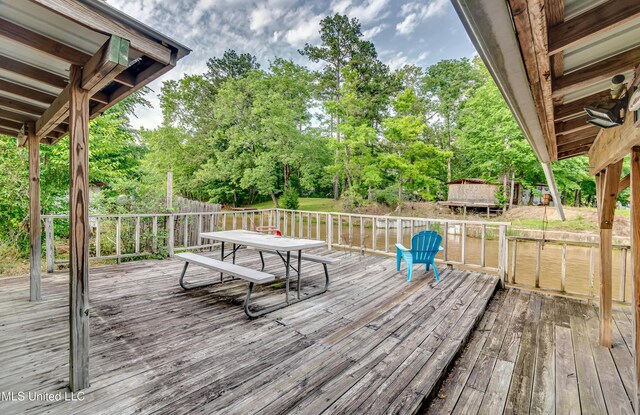 218 Harbor Ln, Brandon, MS 39047 - wooden deck featuring view of wooded area and outdoor dining space