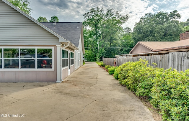 218 Harbor Ln, Brandon, MS 39047 - view of side of property with fence, a patio, and roof with shingles