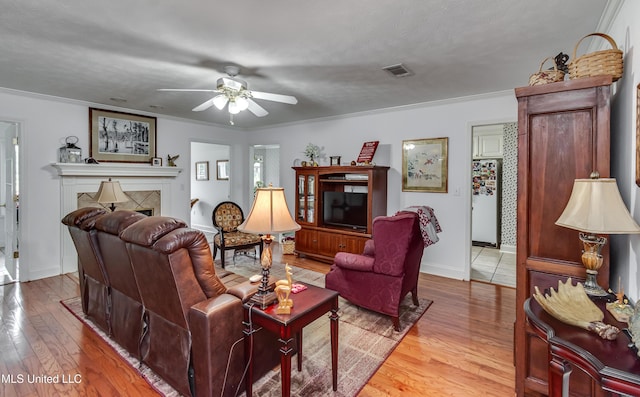 218 Harbor Ln, Brandon, MS 39047 - living area featuring a ceiling fan, ornamental molding, wood finished floors, baseboards, and a fireplace