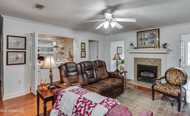 218 Harbor Ln, Brandon, MS 39047 - living room featuring a ceiling fan, wood finished floors, crown molding, and a tiled fireplace