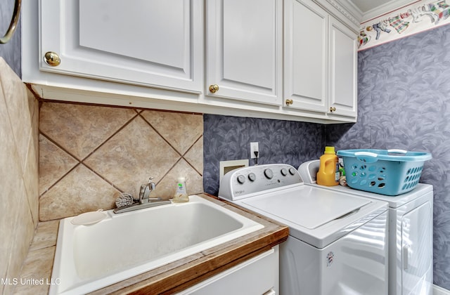 218 Harbor Ln, Brandon, MS 39047 - clothes washing area with wallpapered walls, washing machine and dryer, and cabinet space