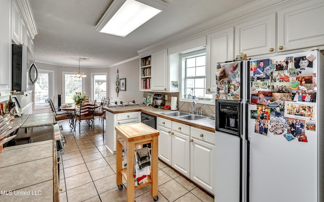 218 Harbor Ln, Brandon, MS 39047 - kitchen with appliances with stainless steel finishes, a sink, white cabinetry, wallpapered walls, and crown molding