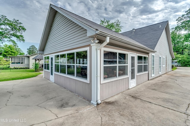 218 Harbor Ln, Brandon, MS 39047 - view of home's exterior with a patio area and a shingled roof