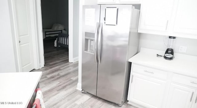 183 Mcdonnell Ave Unit 305, Biloxi, MS 39531 - kitchen featuring stainless steel fridge, white cabinetry, light countertops, and light wood-style floors