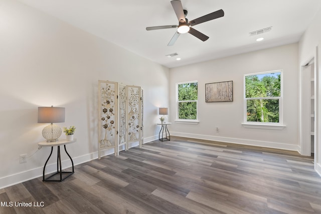 interior space with ceiling fan and dark hardwood / wood-style floors