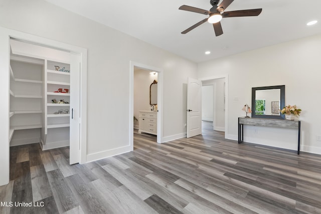 bedroom featuring ceiling fan, wood-type flooring, and ensuite bath