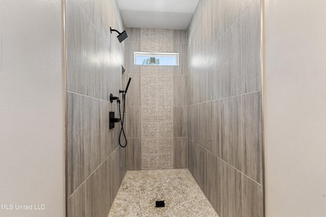 bathroom with tiled shower