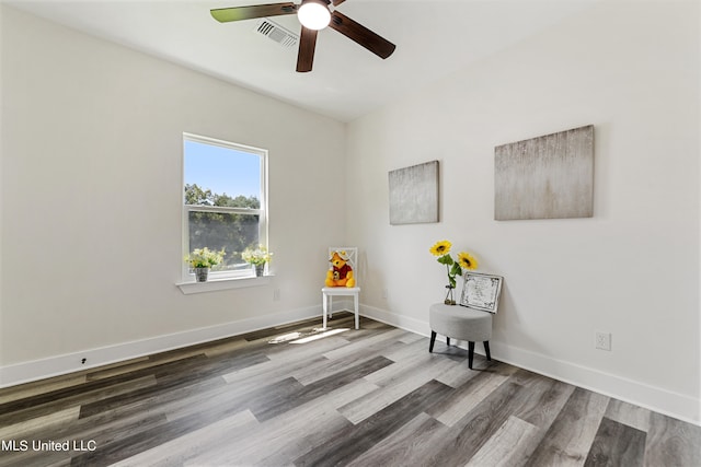 sitting room with hardwood / wood-style flooring and ceiling fan