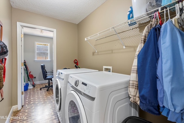 9948 Victor Dr, Olive Branch, MS 38654 - washroom featuring washer and dryer, baseboards, and a textured ceiling