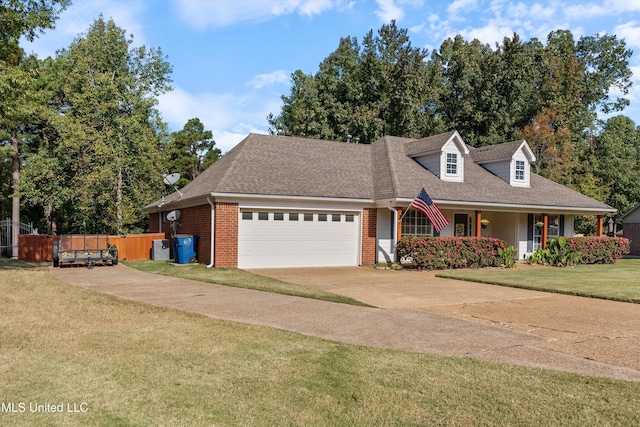 9948 Victor Dr, Olive Branch, MS 38654 - cape cod home featuring an attached garage, brick siding, concrete driveway, and a porch