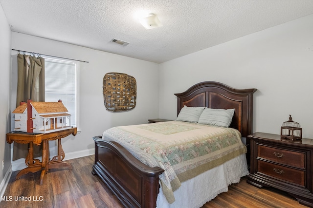 9948 Victor Dr, Olive Branch, MS 38654 - bedroom featuring dark wood finished floors, baseboards, and a textured ceiling