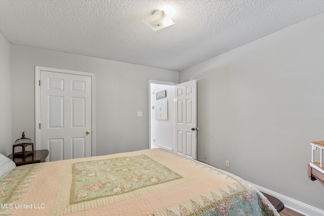 9948 Victor Dr, Olive Branch, MS 38654 - bedroom featuring a textured ceiling and baseboards
