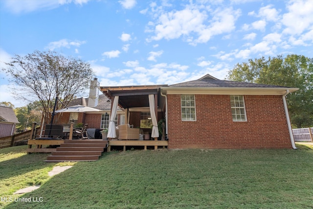 9948 Victor Dr, Olive Branch, MS 38654 - back of property with brick siding, a wooden deck, and a chimney