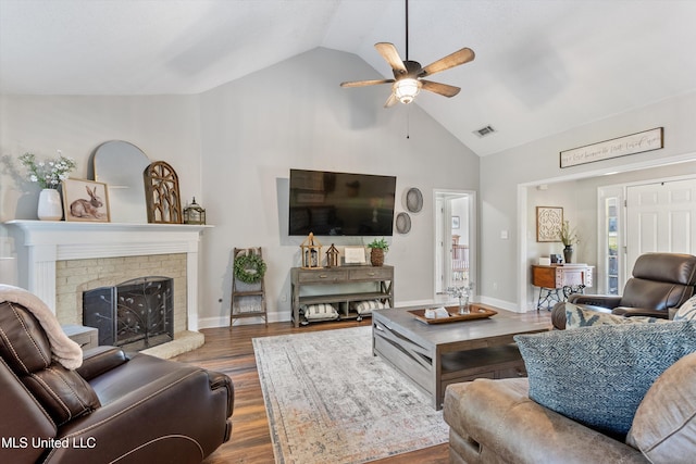 9948 Victor Dr, Olive Branch, MS 38654 - living area featuring ceiling fan, wood finished floors, high vaulted ceiling, a brick fireplace, and baseboards