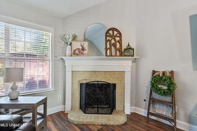 9948 Victor Dr, Olive Branch, MS 38654 - living room featuring a brick fireplace, wood finished floors, and baseboards