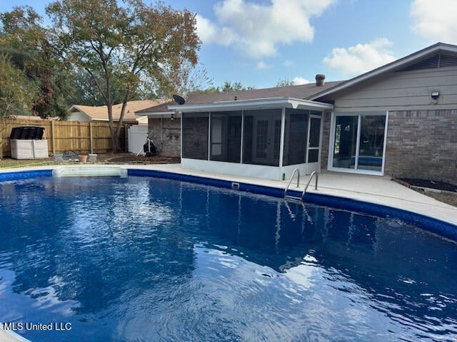 view of pool featuring a sunroom