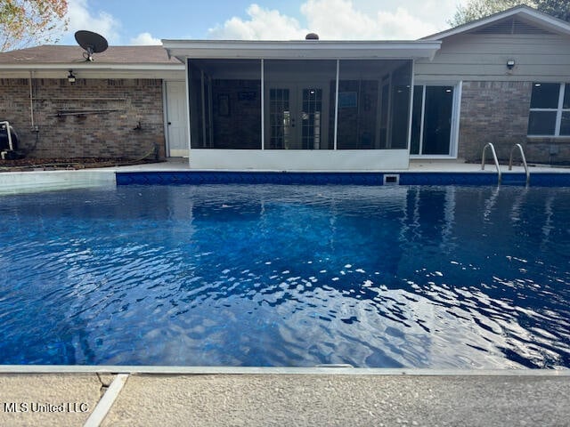 view of pool with a sunroom