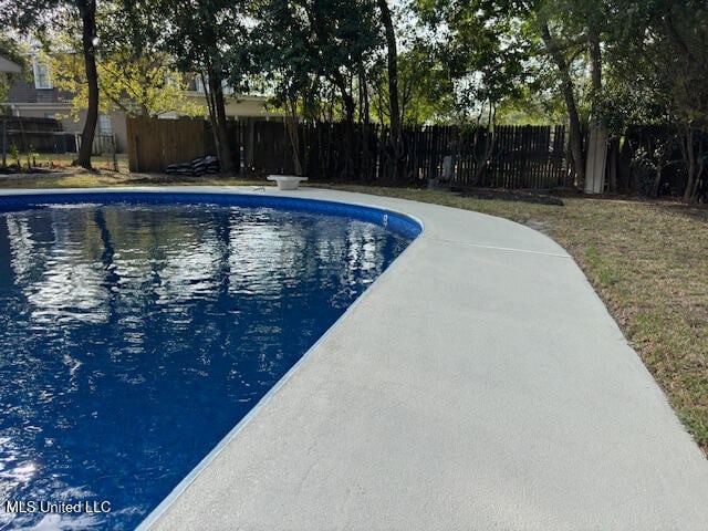 view of pool featuring a diving board