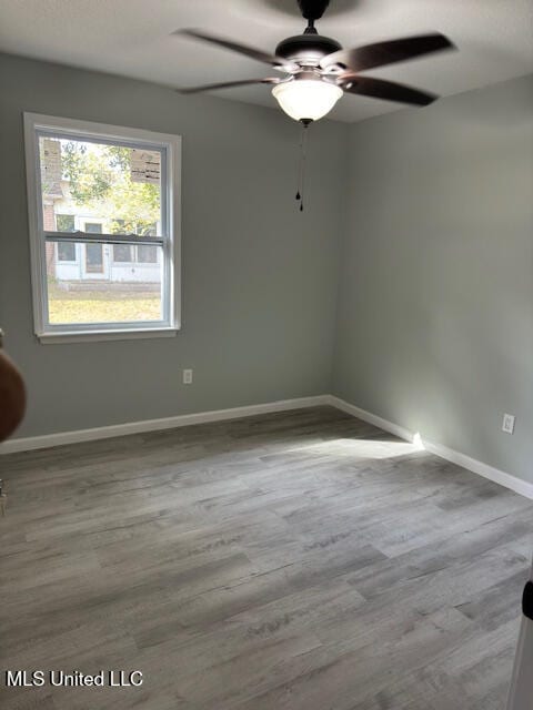 empty room with light hardwood / wood-style floors and ceiling fan