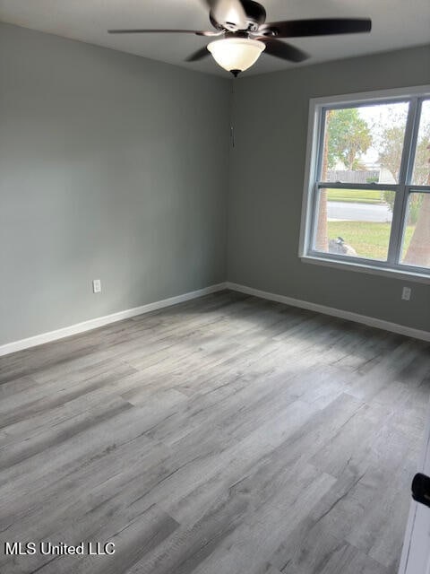 unfurnished room featuring hardwood / wood-style flooring and ceiling fan