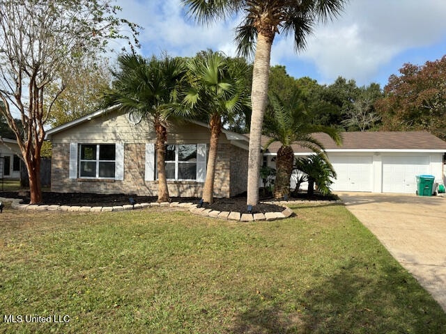 ranch-style house with a garage and a front lawn