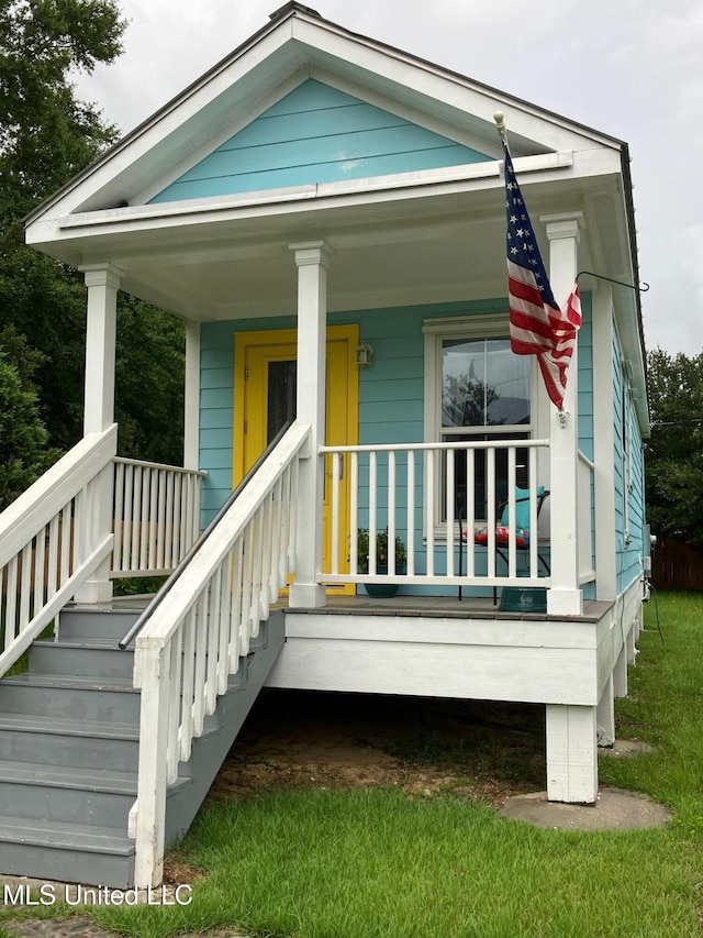305 S Cleveland Ave, Long Beach, MS 39560 - view of front of home featuring a porch, stairway, and a front yard