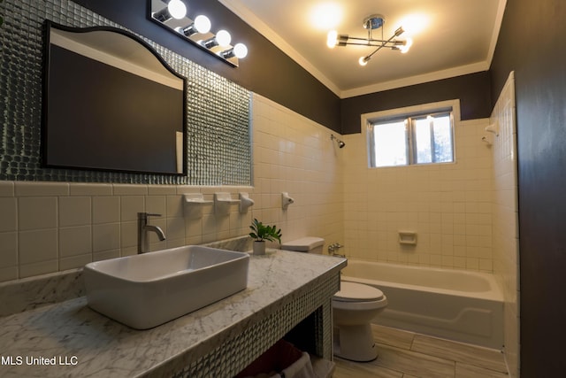 bathroom with toilet, a wainscoted wall, ornamental molding, tub / shower combination, and tile walls