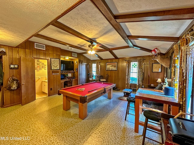 recreation room with ceiling fan, a textured ceiling, billiards, and wood walls