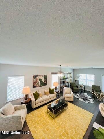 living room with wood finished floors and a textured ceiling