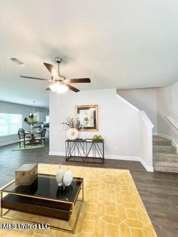 living room featuring ceiling fan and hardwood / wood-style floors