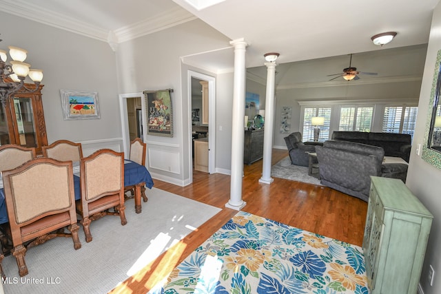 dining space featuring crown molding, hardwood / wood-style flooring, ornate columns, and ceiling fan with notable chandelier