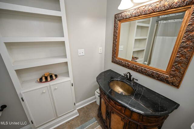 bathroom with walk in shower, tile patterned flooring, and vanity