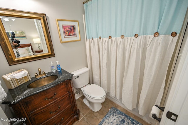 bathroom with toilet, vanity, tile patterned floors, and curtained shower