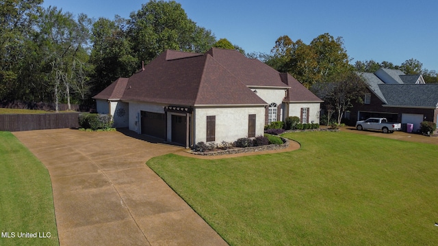 view of front facade featuring a front yard and a garage