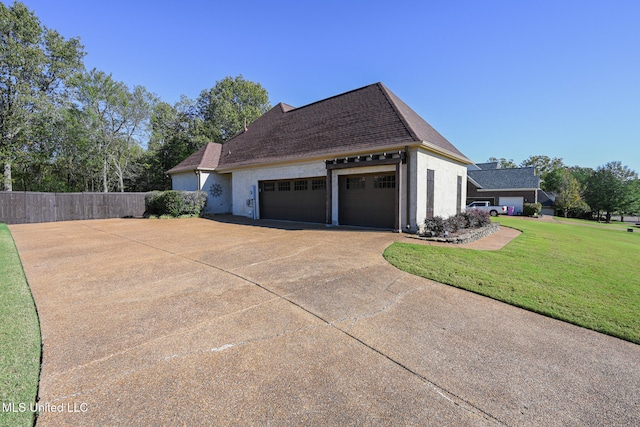 view of side of property with a garage and a yard