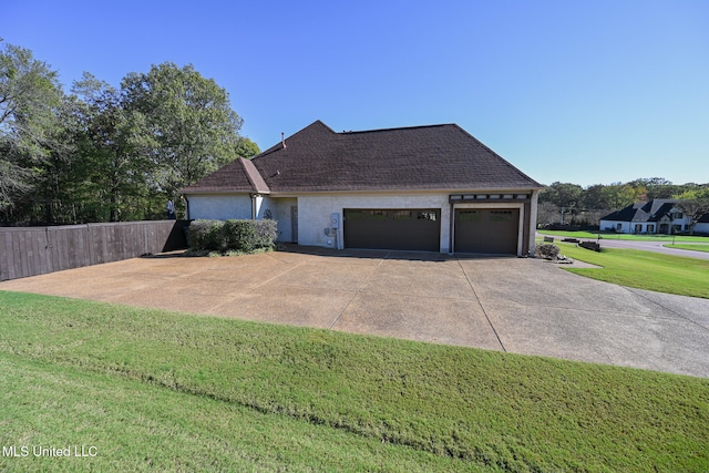 view of front of home featuring a garage and a front lawn