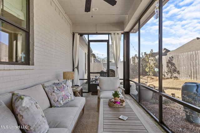 sunroom featuring ceiling fan