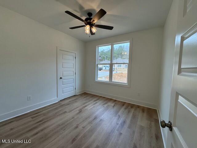 empty room with light wood-type flooring and ceiling fan