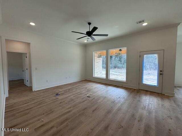 interior space featuring ceiling fan, ornamental molding, and hardwood / wood-style floors