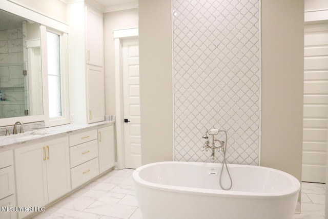 full bath with vanity, a soaking tub, and marble finish floor