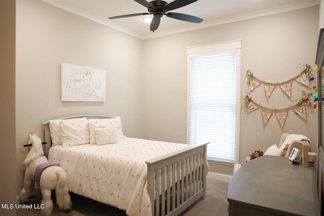 bedroom with a ceiling fan, crown molding, baseboards, and dark colored carpet